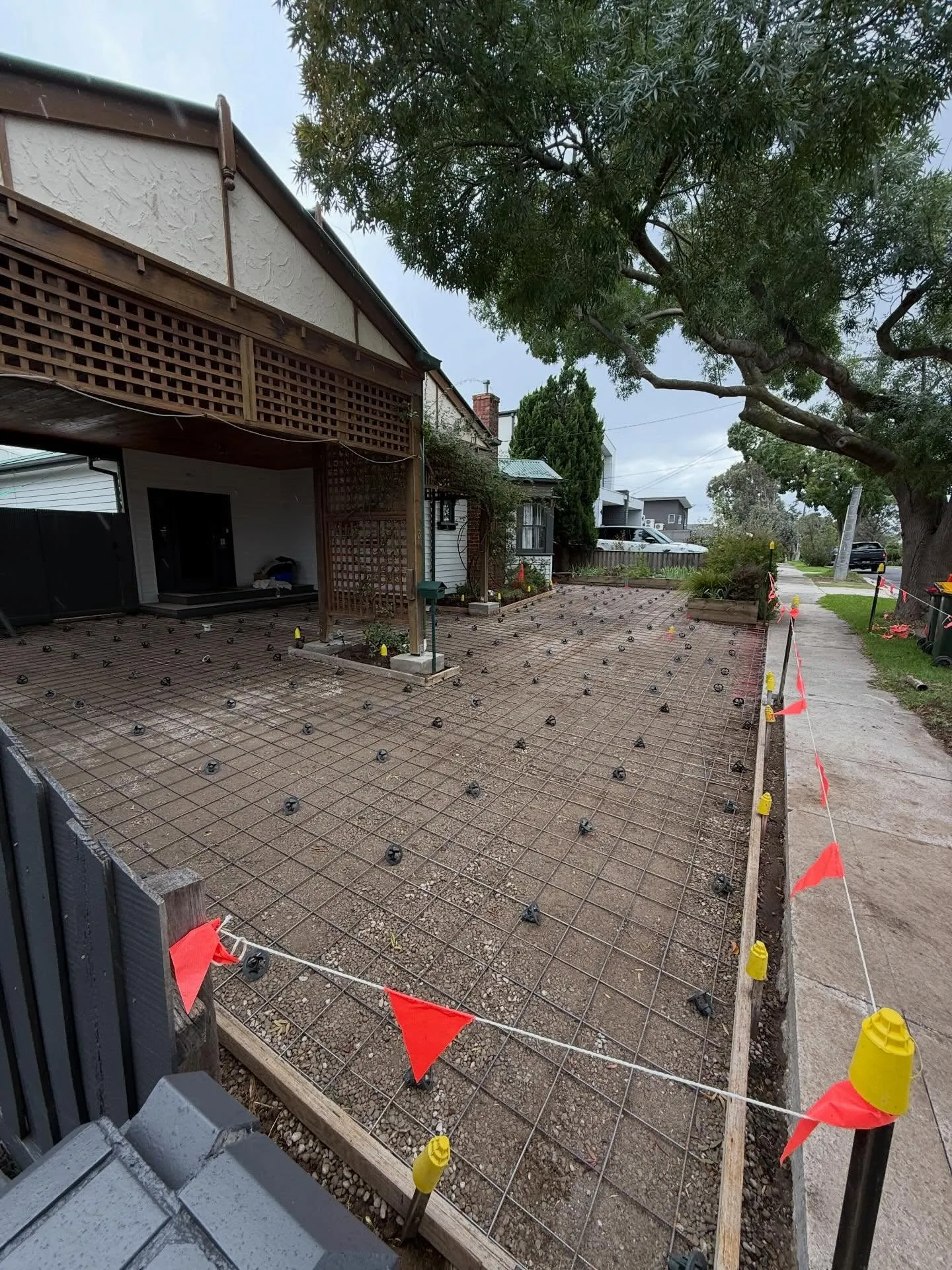Driveway mesh and chairs laid across the full front yard of the period home pre-pour