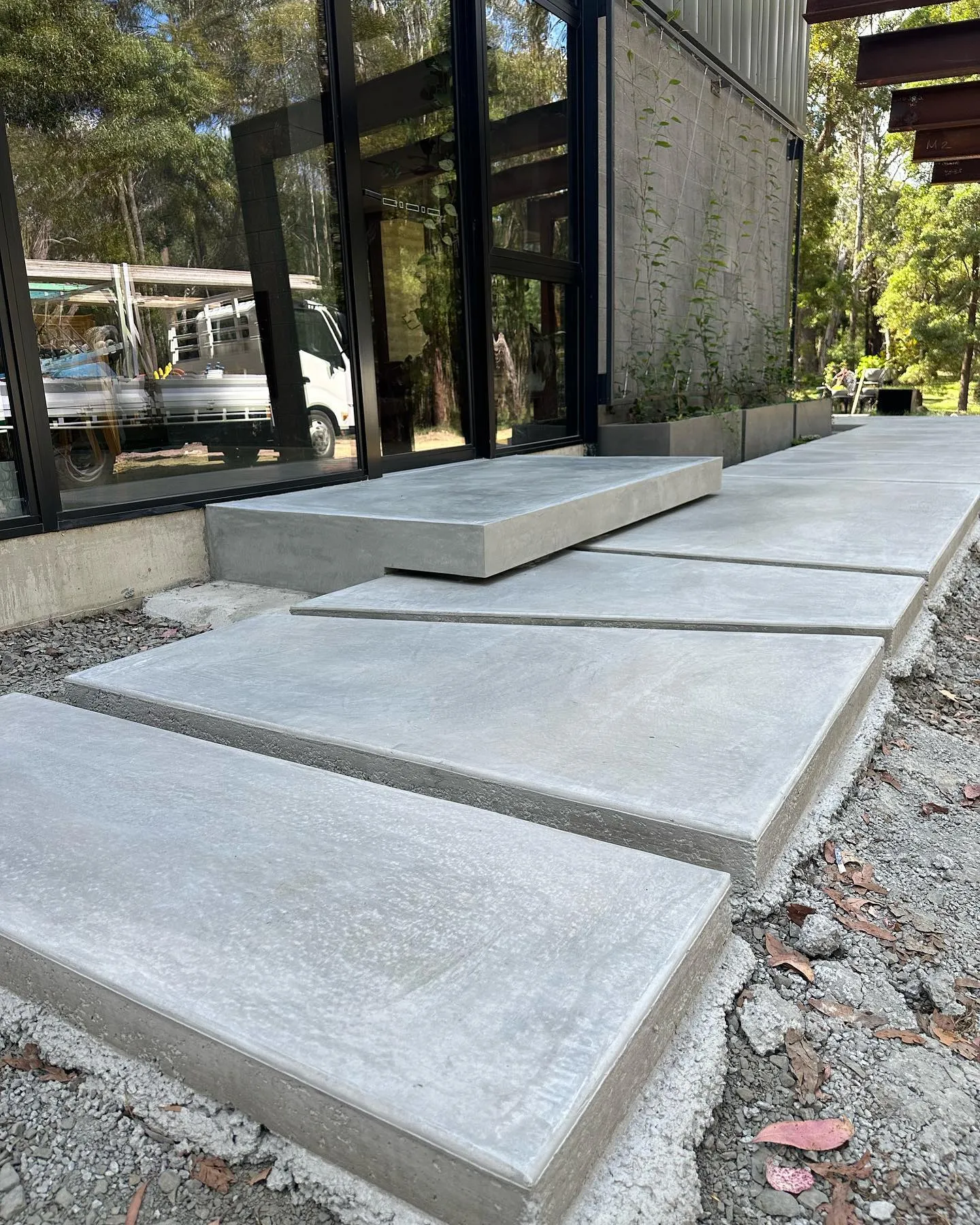 Tight crop of the staggered offset concrete pads showing texture, shadow and crisp edges