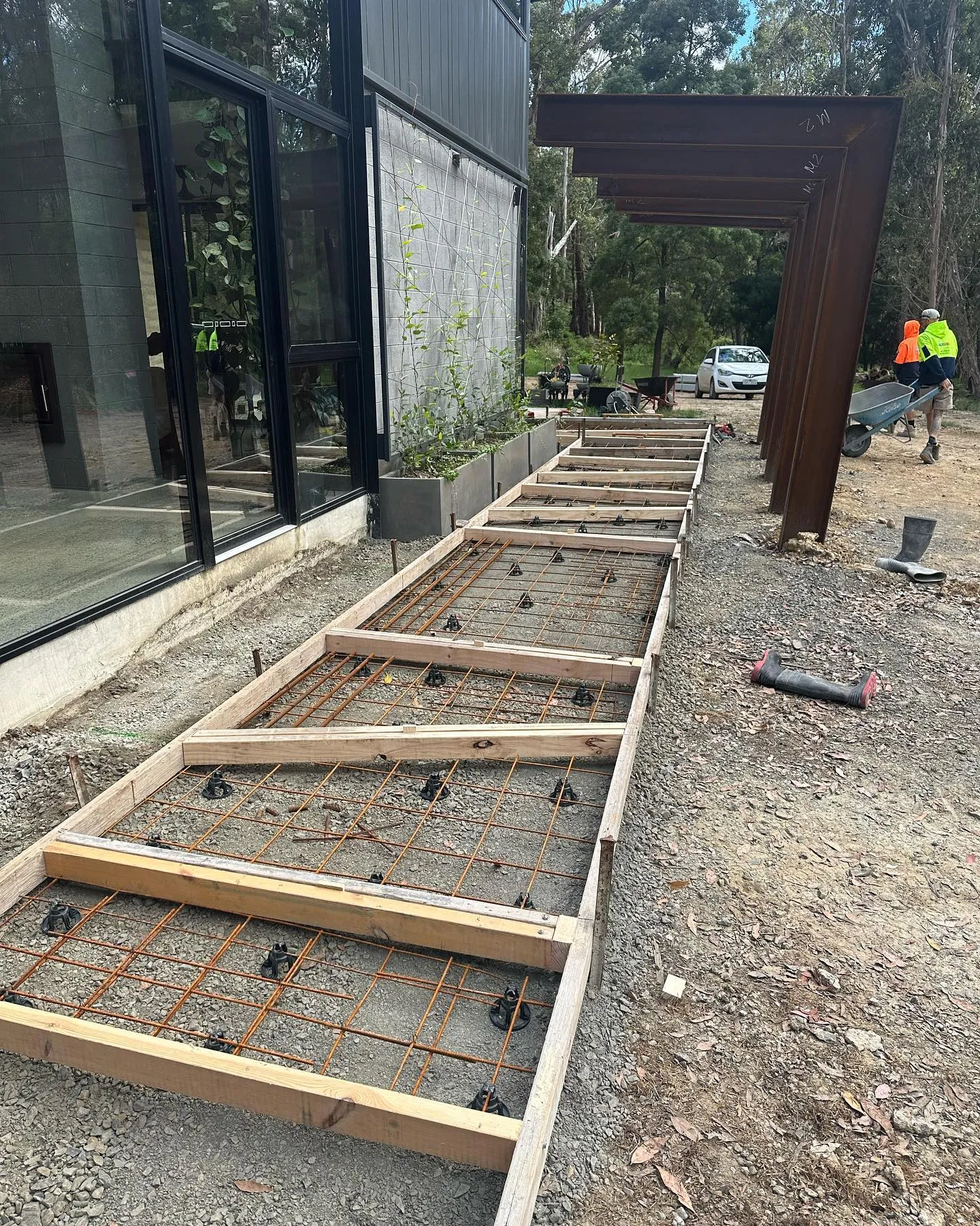 Timber-framed wedge formwork ready for offset architectural pads at the same home
