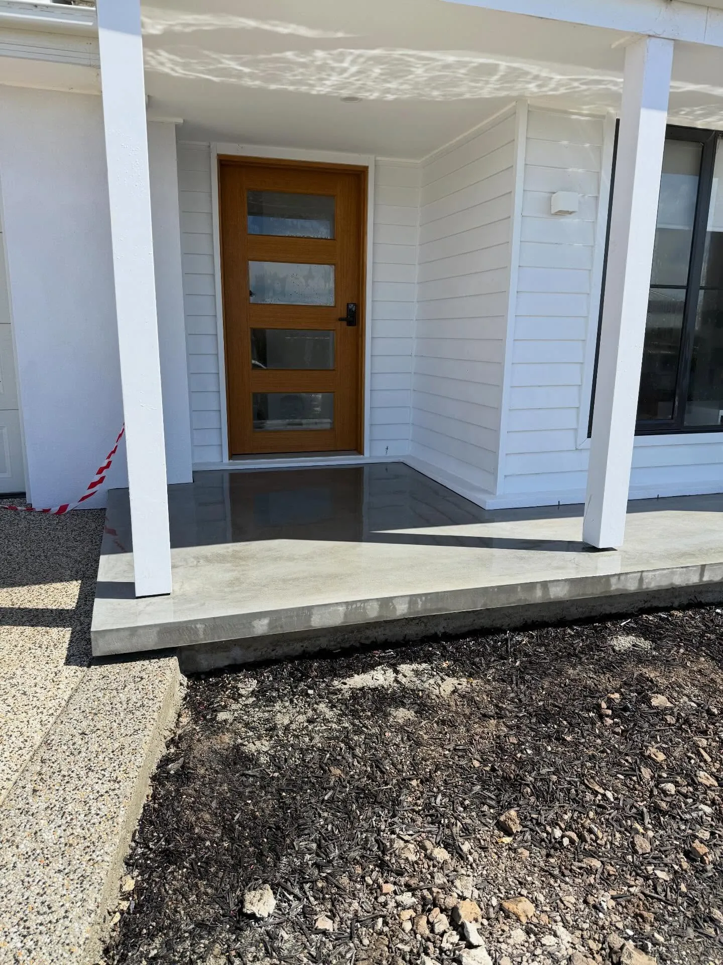 Small charcoal porch slab and step at the front door of a new build home