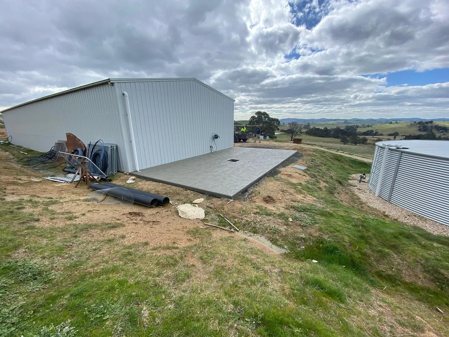 Wet-look sealed shed floor with a high-gloss reflective grey finish inside a steel shed