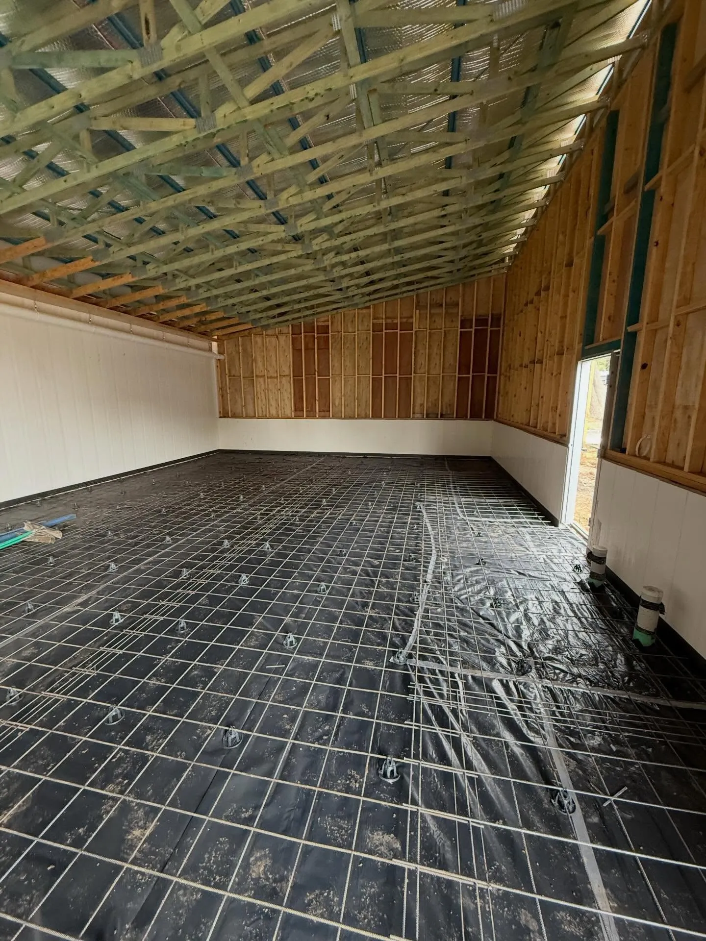 Empty shed interior with mesh on plastic ready for pour ahead of sealing