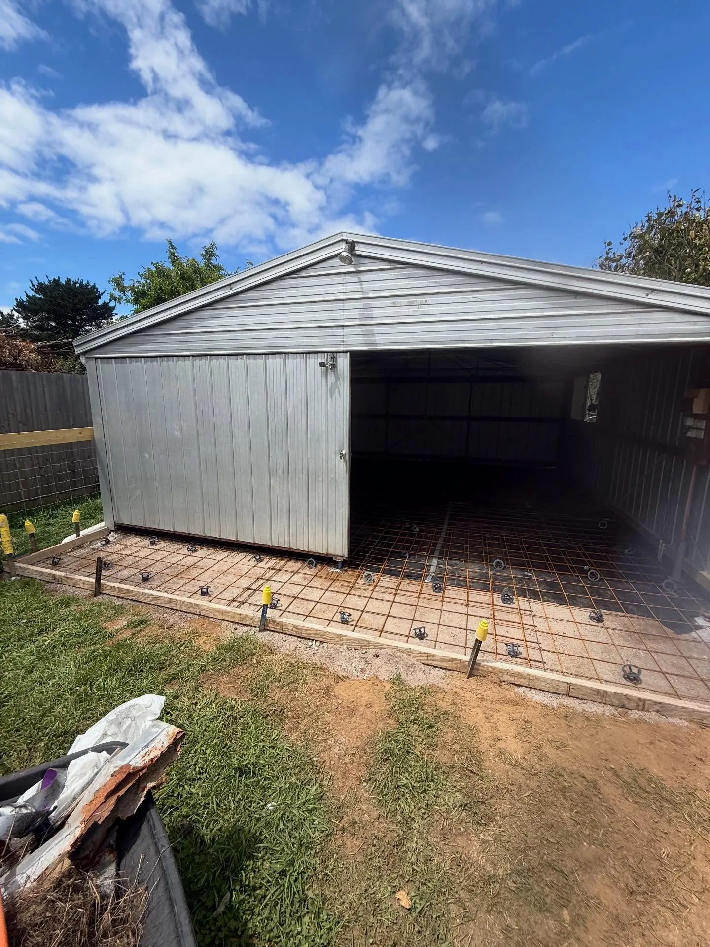 Small garage with new mesh laid on plastic ready for the floor pour